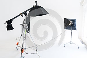 Empty photo studio with lighting equipment. Photographer workplace interior with professional tool set gear. Flash light