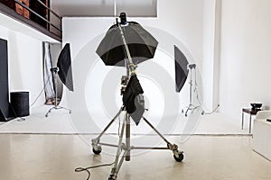 Empty photo studio with lighting equipment. Photographer workplace interior with professional tool set gear. Flash light