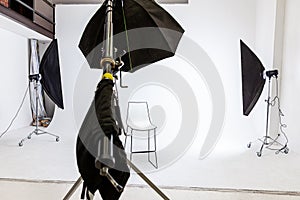 Empty photo studio with lighting equipment. Photographer workplace interior with professional tool set gear. Flash light