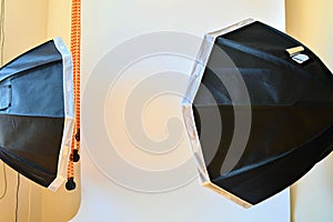 Empty photo studio with lighting equipment. White background in photo studio