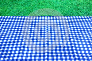 Empty Picnic Table With Blue White Tablecloth Background