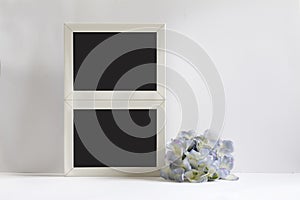 Empty picture frame, decorated with blueflowers