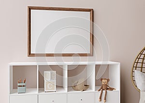 Empty picture frame on light brown wall in modern child room. Mock up interior in scandinavian, boho style. Free, copy