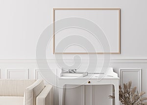 Empty picture frame on white wall in modern living room. Mock up interior in contemporary style. Close up view. Free