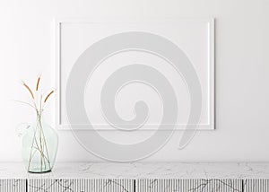 Empty picture frame on white wall in modern living room. Mock up interior in minimalist, scandinavian style. Free space