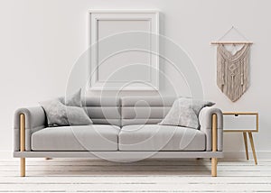 Empty picture frame on white wall in modern living room. Mock up interior in scandinavian, boho style. Free space, copy