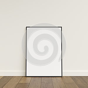 Empty picture frame on wooden floor leaning against wall. Blank poster frame standing on wooden floor. Blank poster frame mockup.