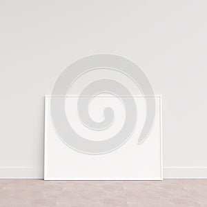 Empty picture frame on wooden floor leaning against wall. Blank poster frame standing on wooden floor. Blank poster frame mockup.