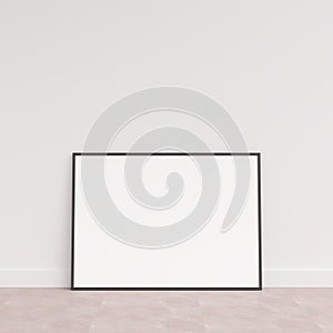 Empty picture frame on wooden floor leaning against wall. Blank poster frame standing on wooden floor. Blank poster frame mockup.