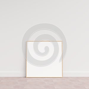 Empty picture frame on wooden floor leaning against wall. Blank poster frame standing on wooden floor. Blank poster frame mockup.