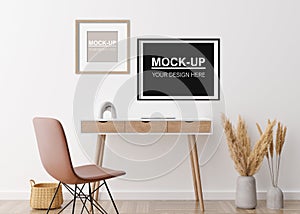 Empty picture frames on the wall in modern home office. Frame mock up. Interior in scandinavian, boho style. Copy space