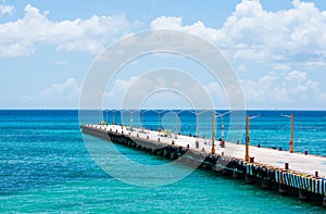 Empty pier for ferries on blue Caribbean sea.