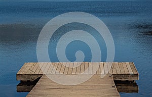 Empty pier in the summer. Wooden jetty at the lake
