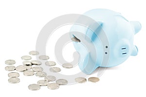 Empty piggy bank and coins on white background