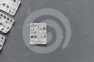 Empty pill blister on gray background, supplement concept