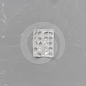 Empty pill blister on gray background, supplement concept