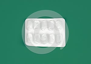 Empty pill packets. top view isolated empty white medicine package on green background