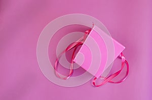 Empty pink gift box on a pink background.