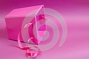 Empty pink gift box on a pink background