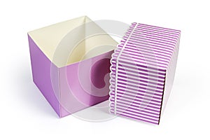 Empty pink rectangular cardboard gift box and removed striped lid