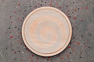 Empty pizza platte with spices set up on dark concrete background flat lay and copy space