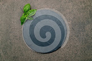 Empty pizza platter for homemade baking set up on dark concrete. Food recipe concept on dark stone background texture with copy