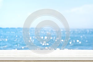 Empty plank white wood table top with blur blue sky and sea boekh background,summer holiday backdrop.Mock up template for display