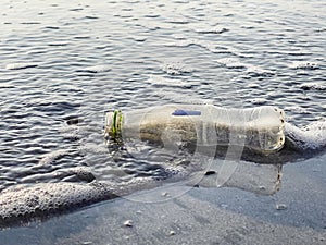 An empty plastic bottle was left on the beach