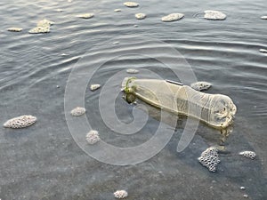 An empty plastic bottle was left on the beach