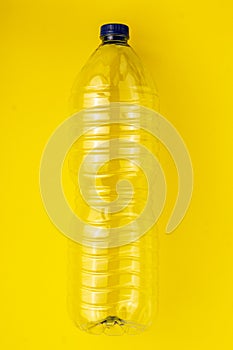 Empty plastic bottle on a yellow background