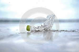 Empty plastic bottles on the beach, thrown away at the seaside. volunteer concept, Environmental pollution