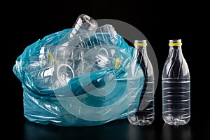 Empty plastic bottles in a garbage bag. Household waste collected in a blue bag