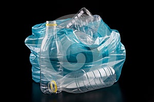 Empty plastic bottles in a garbage bag. Household waste collected in a blue bag