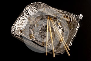 An empty plastic container for the delivery of a set of sushi