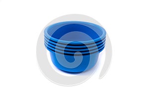 Empty plastic deep plates of different colors on a white background. Several plates.