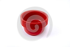 Empty plastic deep plates of different colors on a white background. Several plates.