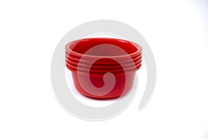 Empty plastic deep plates of different colors on a white background. Several plates.