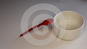 Empty plastic dinnerware on white table background