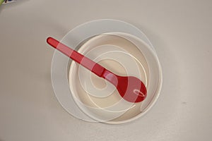 Empty plastic dinnerware on white table background