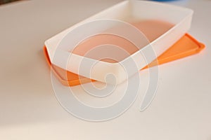 Empty plastic dinnerware on white table background