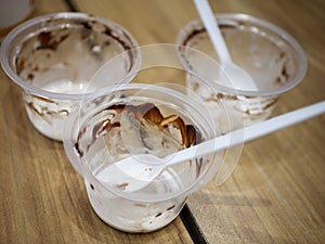 Empty plastic ice cream cups and spoon