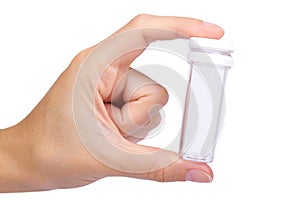 Empty plastic medical pharmaceutical sterile ampule bottle in hand isolated on the white background, transparent container