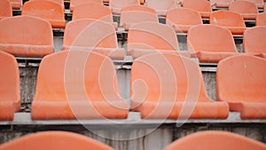 Empty Plastic Seats at Stadium. Rows of Orange Seats at Football Stadium Tribune Without Spectators and Fans