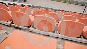 Empty Plastic Seats at Stadium. Rows of Orange Seats at Football Stadium Tribune Without Spectators and Fans