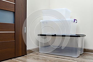 Empty plastic storage boxes stacked on the floor of the room