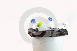 Empty plastic water bottle in recycling bin waiting to be taken to recycle. Concept save the earth