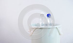 Empty plastic water bottle in recycling bin waiting to be taken to recycle. Concept save the earth