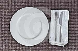 Empty plate and cutlery on multiplex plate