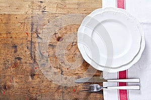 empty plate with cutlery on a wooden background. space for writing or placing text menu