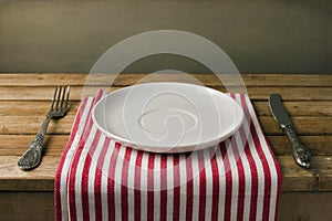 Empty plate with fork and knife